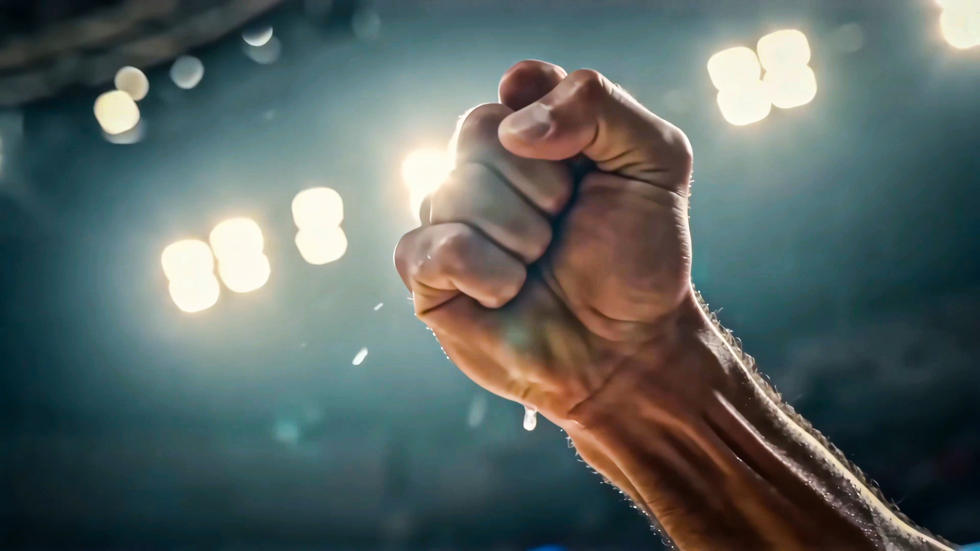 A raised hand beneath the arena lights in BASKETBALL