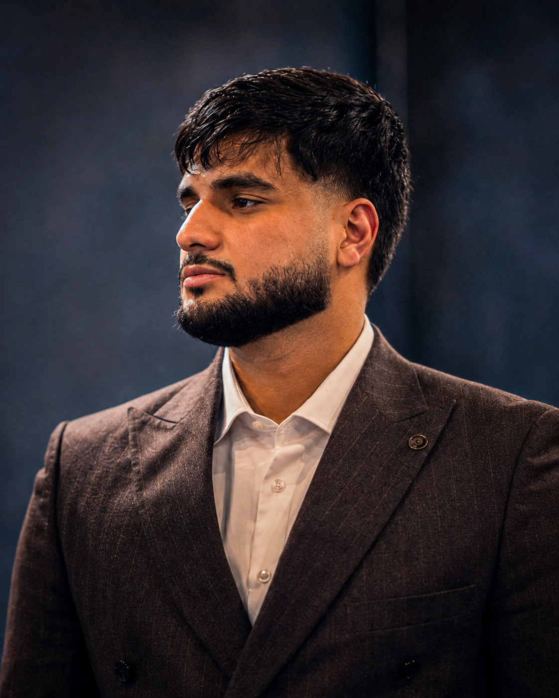 Yousef Al Jumaily wearing a brown suit